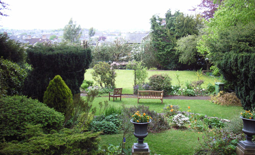 View south over garden with seating and tennis court